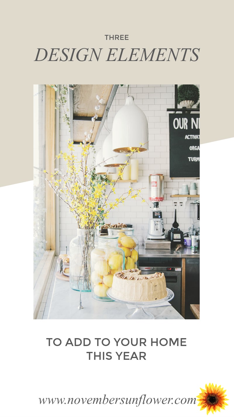 Kitchen counter with display of cake and flower. Background subway tiles.