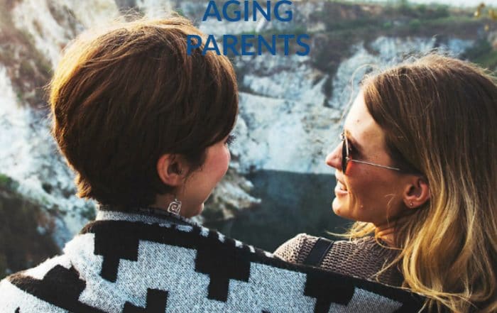 aging parents - mom and daughter wrapped in blanket looking at one another